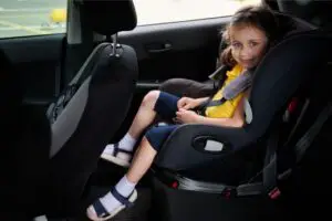 Learning the correct way to put a seat belt in your child's booster seat